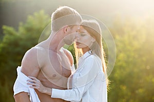Sensual portrait of young couple in love. Loving couple embracing and kissing.