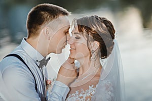 Sensual portrait of a young couple. Wedding photo outdoor. Wedding shot of bride and groom in park. Just married couple