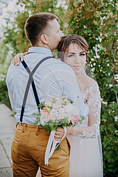 Sensual portrait of a young couple. Wedding photo outdoor. Wedding shot of bride and groom in park. Just married couple