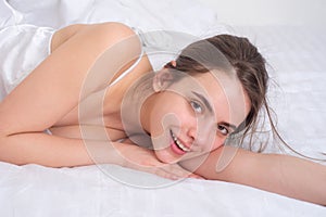 Sensual portrait of young woman in bed. Beautiful girl model.