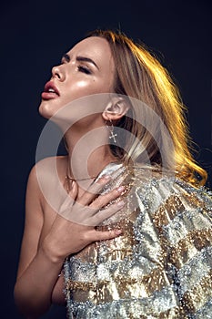 Sensual, relaxed lady posing over a dark background