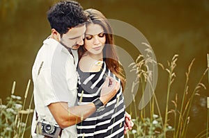 Sensual romantic couple in love at the lake in summer day, beaut