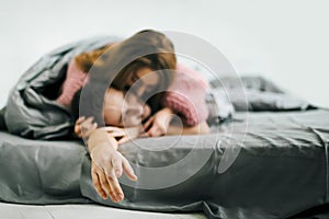 Sensual romantic foreplay by couple in love in bed. Arrwork. Soft focus on the hand