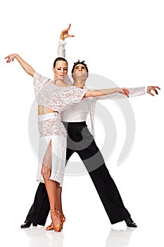 Sensual salsa dancing couple making a dance move and posing for