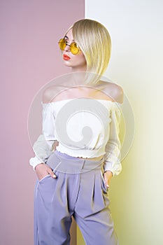 Sensual stylish woman in erotic white dress. Blue-eyed lady with perfect lips in modern colour sunglasses