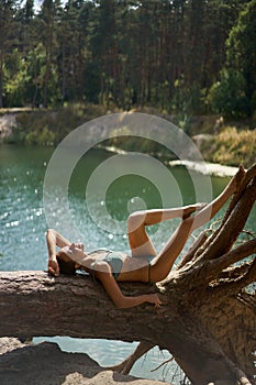 Sensual Summer Bikini Woman Lounging by the Lake