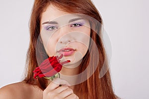 Sensual teen girl holds a rose in hand
