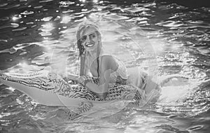 Sensual woman. Adventures of girl on crocodile. woman on sea with inflatable mattress. Relax in luxury swimming