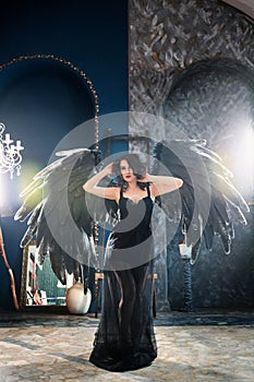 Sensual woman in black angel costume