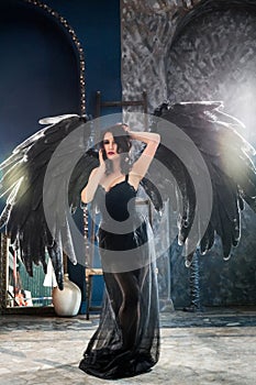 Sensual woman in black angel costume