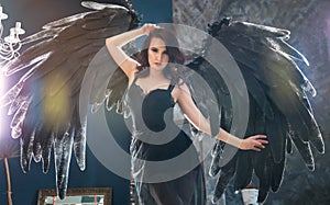 Sensual woman in black angel costume