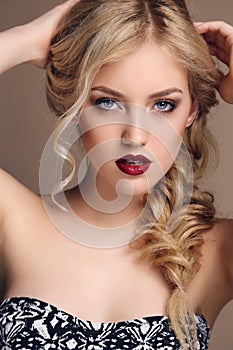 Sensual woman with blond curly hair with bright makeup