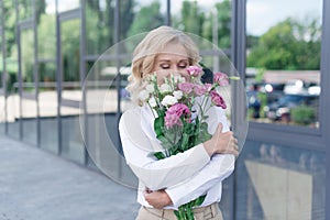 sensual woman holding bouquet of flowers