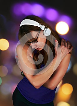 Sensual Woman lost in listening to music hugging herselff