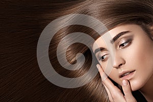 Sensual woman model with straight dark hair. Shiny long health hairstyle