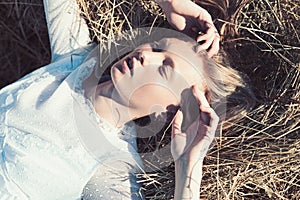 Sensual woman relax on hay. Woman with natural look. Albino girl with long blond hair. Beauty model with young face skin