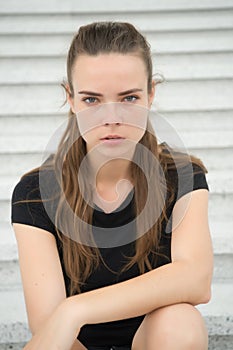 Sensual woman relax on steps in paris, france. Woman with long hair on staircase. Girl with young look and beauty. Fashion model w