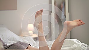 Sensual woman resting with legs up. Close up of woman feet in air