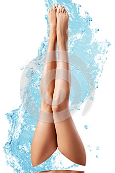 Sensual woman`s legs in clean water splashes.