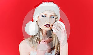 Sensual Woman in santa hat with Christmas tree ball. Christmas time and New year celebrating. Winter holidays.