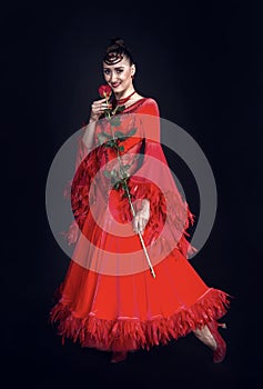 Sensual woman smile with rose flower on dark background