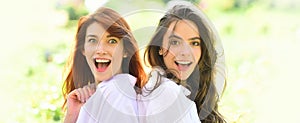 Sensual woman spring outdoor portrait banner. Two excited women friends girls posing on green nature background. People
