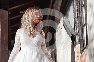 Sensual woman on staircase. Woman bride in white wedding dress. Girl with glamour look. Fashion model.