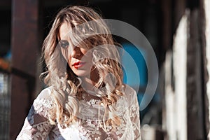 Sensual woman on staircase. Woman bride in white wedding dress. Girl with glamour look. Fashion model.