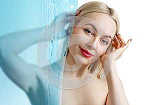 Sensual woman under water splash over white background.