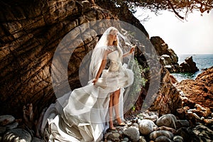 Sensual woman in wedding dress posing outdoor.