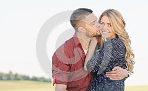 sensual young couple in love kissing outside on the sunset in summer day