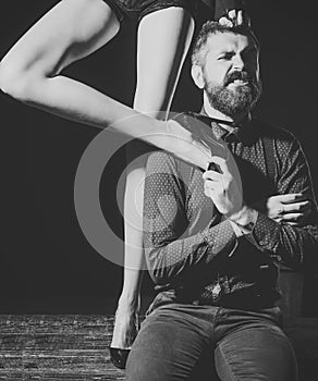 Sensual young couple making love. Man in shirt isolated on black background, matriarchy
