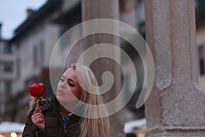 Sensual young woman eyeing a toffee apple with anticipation