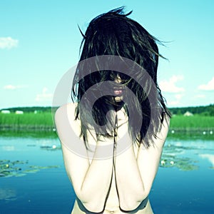 Sensual young woman on lake