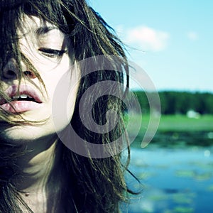 Sensual young woman on lake