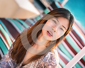 Sensuality beautiful woman sitting on a beach sofa on the beach side for Vacation and Relaxation cocnept