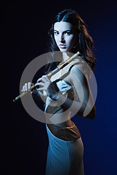 Sensuality brunette with a wooden flute photo