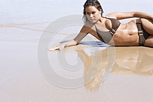 Sensuous Woman In Bikini Lying On Water
