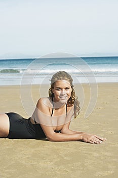 Sensuous Woman In Swimsuit Lying On Beach