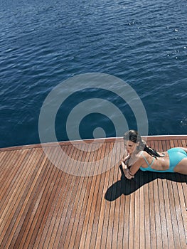 Sensuous Woman In Swimsuit Relaxing On Yacht