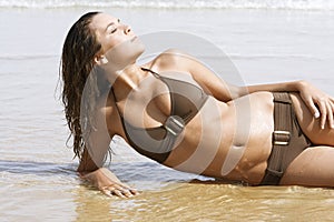 Sensuous Young Woman In Bikini Lying On Water