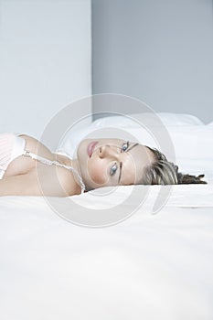 Sensuous Young Woman Lying In Bed