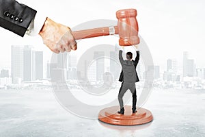 Sentence concept with businessman resists gavel at city background