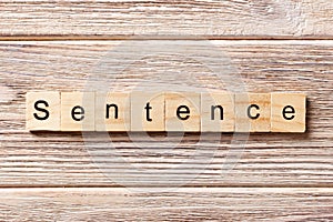 Sentence word written on wood block. Sentence text on table, concept