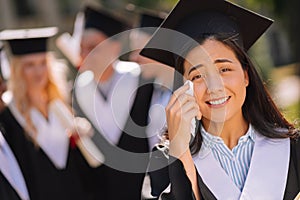 Sentimental girl crying during her graduation ceremony.
