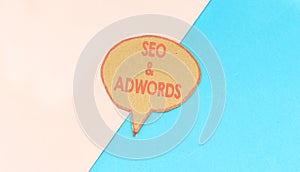 seo and adwords speech bubble isolated on pink and blue background.