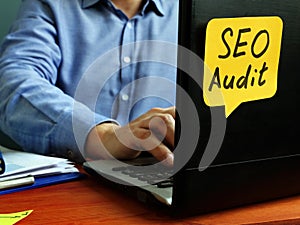 SEO audit concept. Specialist working with laptop