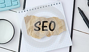 Seo Career. Opened Notebook With Seo-Optimization Scheme Lying Over Brown Office Table Background. Search Engine Optimization For