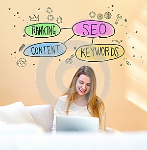 SEO concept with woman using laptop