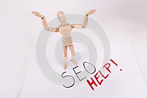 SEO help overwhelmed wooden jointed manikin doll holding up hands